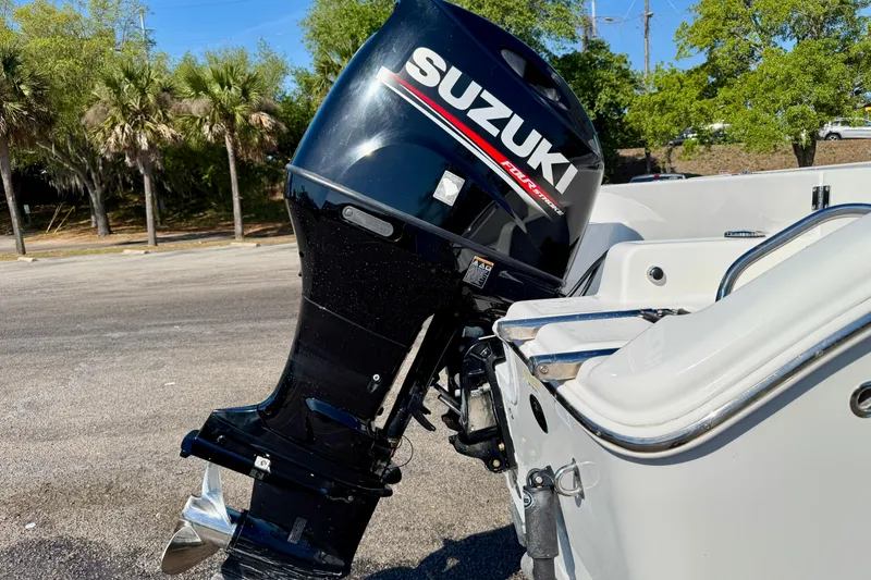 Slide: The Image of 2018 Sea Pro 219 Center Console with Suzuki outboard motor in a sunny setting. - 40