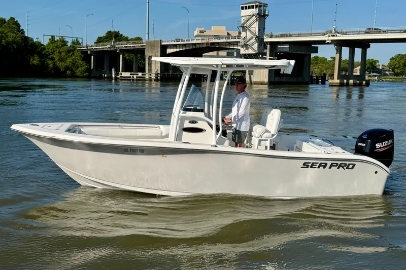 Slide: The Image of 2018 Sea Pro 219 Center Console boat on water near a bridge. - 5