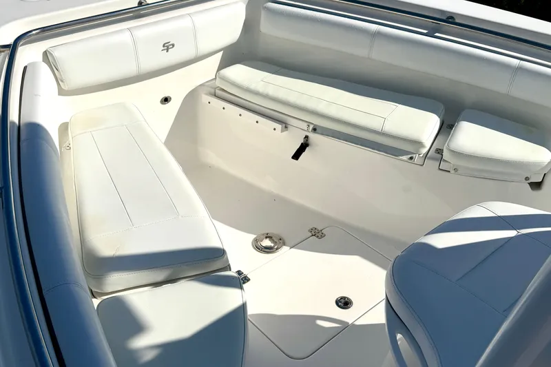 Slide: The Image of 2018 Sea Pro 219 Center Console boat interior with white cushioned seating. - 7
