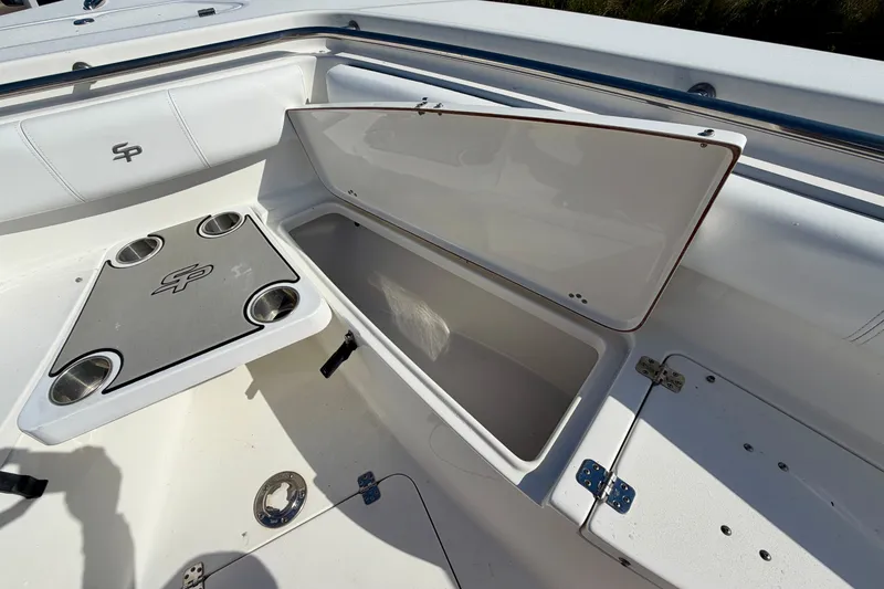 Slide: The Image of 2018 Sea Pro 219 Center Console boat with open storage compartment and cup holders. - 9