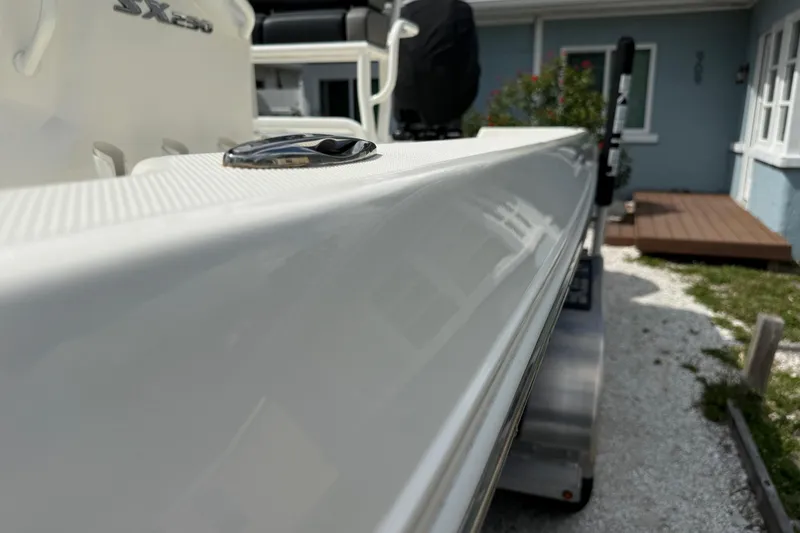 Slide: The Image of 2023 Skeeter SX230 boat detail, showcasing sleek design and polished surface. - 11