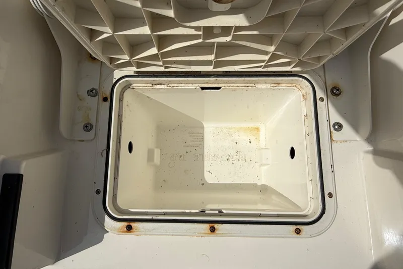Slide: The Image of Open storage compartment on 2023 Skeeter SX230 boat, showing interior details. - 14