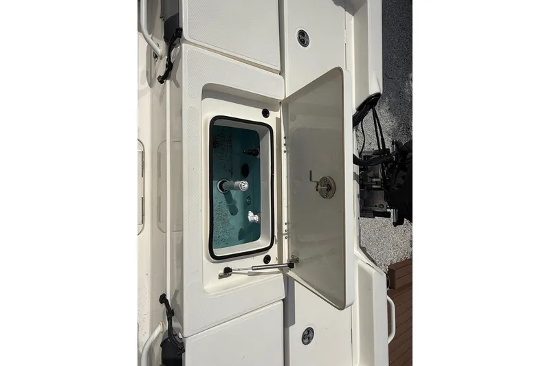 Slide: The Image of 2023 Skeeter SX230 boat livewell with open lid, showcasing interior features. - 15