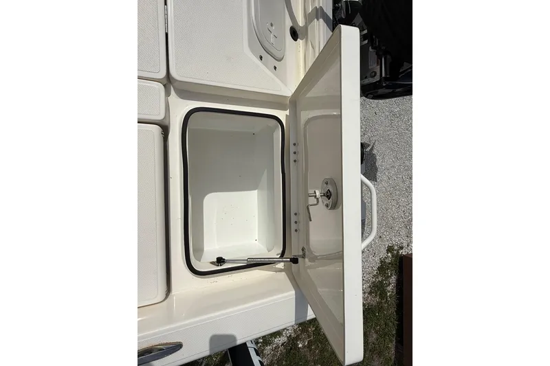 Slide: The Image of Open storage compartment on 2023 Skeeter SX230 boat, showcasing interior space. - 17