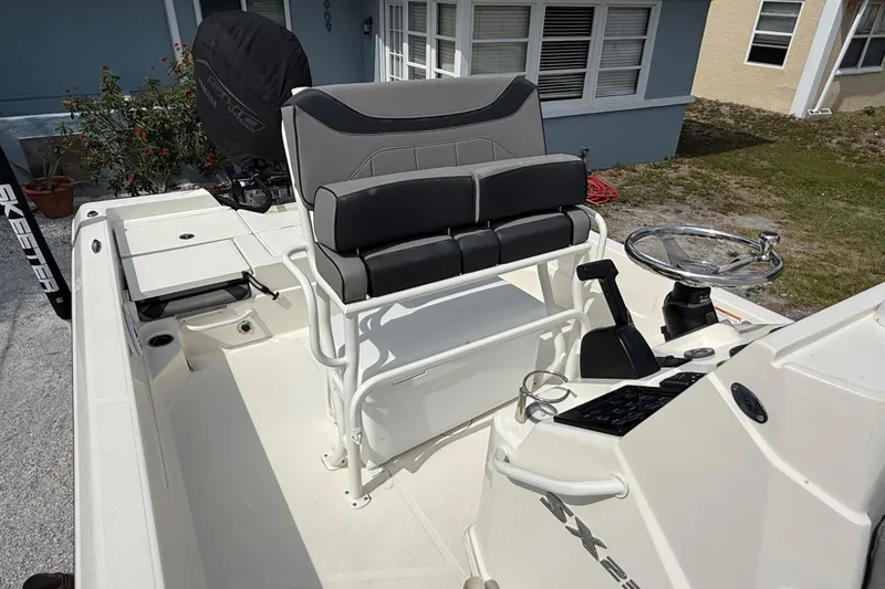 Slide: The Image of 2023 Skeeter SX230 boat interior with seating and steering wheel. - 18