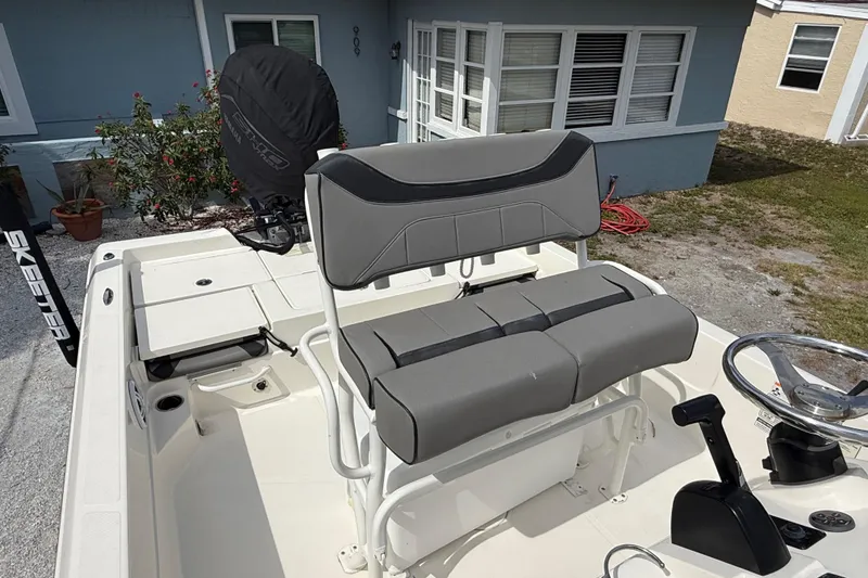Slide: The Image of 2023 Skeeter SX230 boat interior with gray seating and steering console. - 19