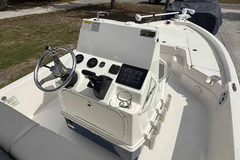 Slide: The Image of 2023 Skeeter SX230 boat interior with steering wheel, controls, and seating. - 21