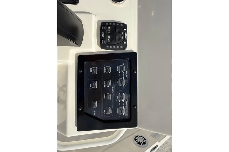 Slide: The Image of 2023 Skeeter SX230 boat control panel with switches and controls. - 22