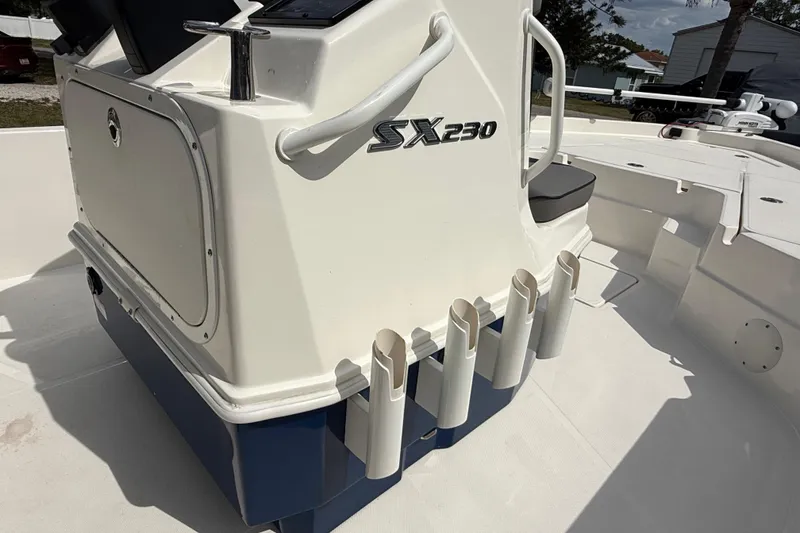 Slide: The Image of 2023 Skeeter SX230 boat interior with rod holders and storage compartment. - 23
