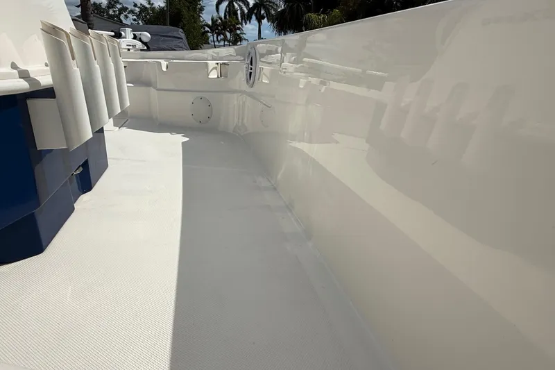 Slide: The Image of 2023 Skeeter SX230 boat interior with rod holders and clean white deck. - 25