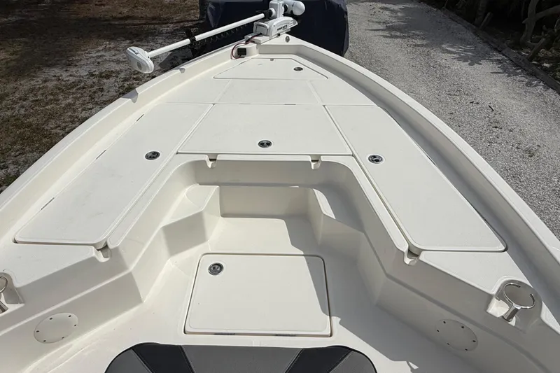 Slide: The Image of 2023 Skeeter SX230 boat deck with storage compartments and trolling motor. - 26