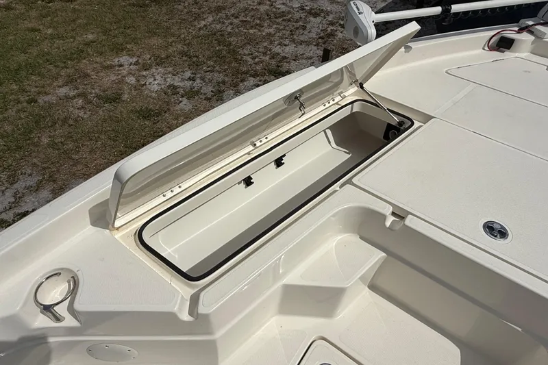 Slide: The Image of 2023 Skeeter SX230 boat storage compartment open, showcasing spacious interior design. - 27