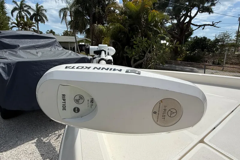 Slide: The Image of Minn Kota Riptide motor on 2023 Skeeter SX230 boat, surrounded by tropical foliage. - 29