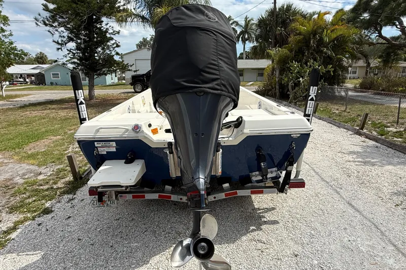 Slide: The Image of 2023 Skeeter SX230 boat on trailer, rear view with covered outboard motor. - 3