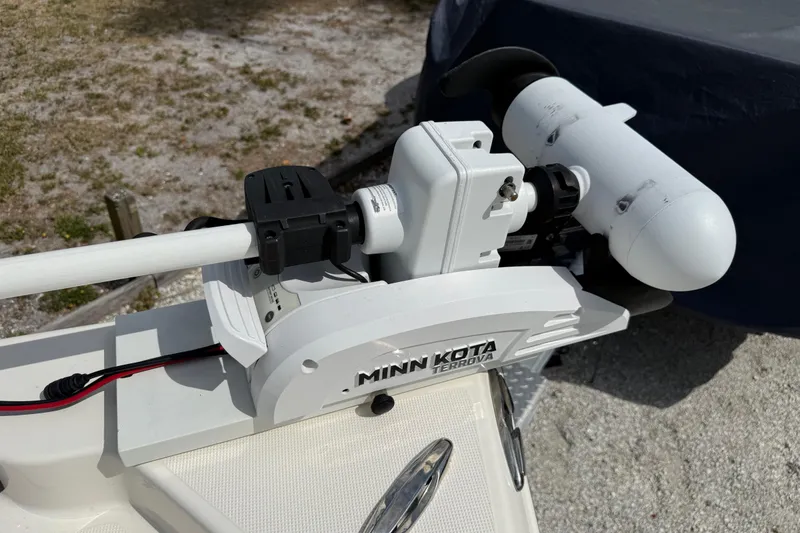 Slide: The Image of Minn Kota Terrova trolling motor on 2023 Skeeter SX230 boat, parked on sandy ground. - 30