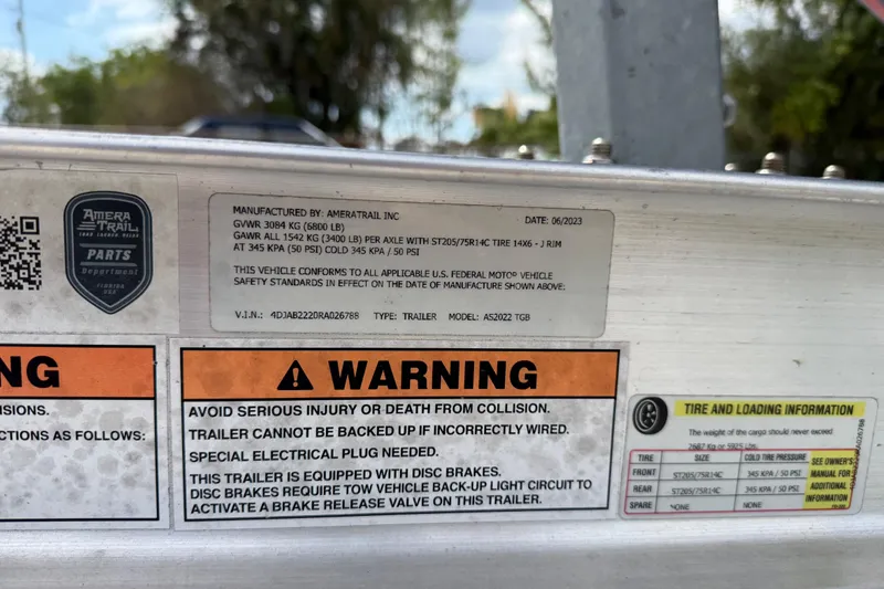 Slide: The Image of Warning label on a 2023 Skeeter SX230 trailer, detailing safety and tire information. - 40