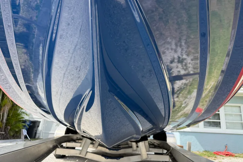 Slide: The Image of 2023 Skeeter SX230 boat hull on trailer, showcasing sleek design and glossy finish. - 6