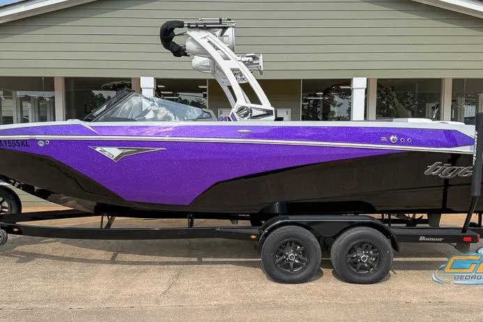 Slide: The Image of 2022 Tigé Z3 boat in vibrant purple and black, displayed on a trailer. - 1