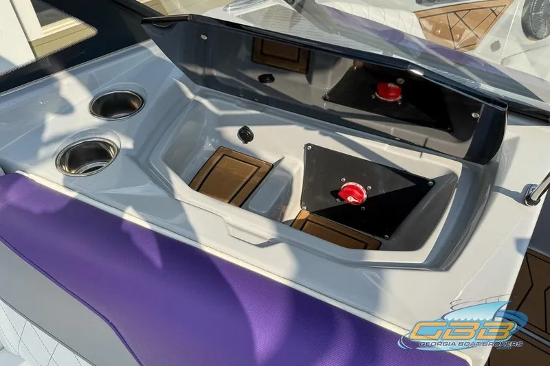Slide: The Image of 2022 Tigé Z3 boat interior with cup holders and control panel, featuring purple upholstery. - 12