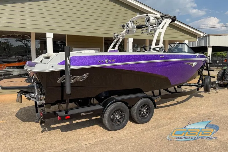 Slide: The Image of 2022 Tigé Z3 boat in vibrant purple on a trailer at a dealership. - 16