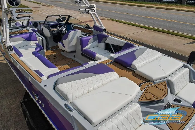 Slide: The Image of 2022 Tigé Z3 boat with luxurious purple and white interior, parked on a street. - 19