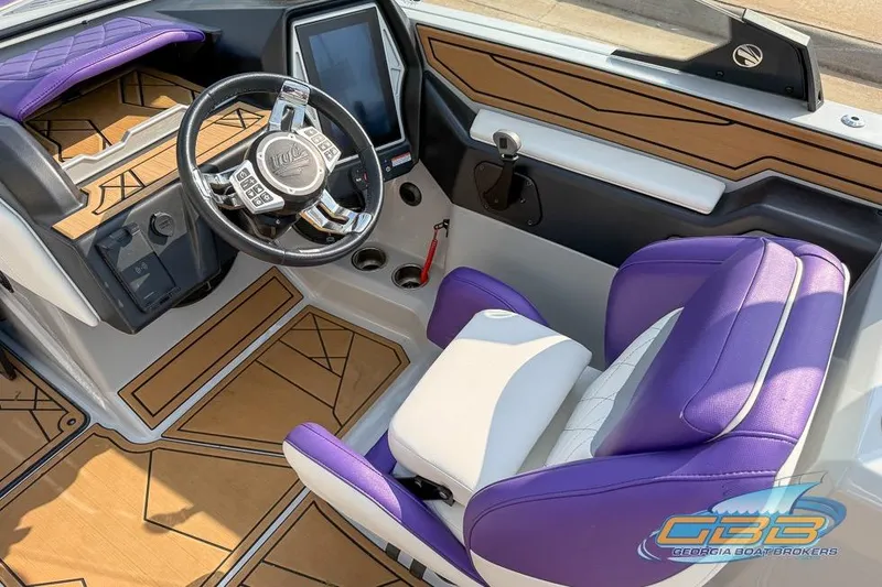 Slide: The Image of Interior of a 2022 Tigé Z3 boat with purple and white seating, modern dashboard. - 2