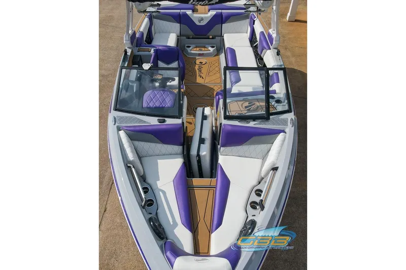 Slide: The Image of 2022 Tigé Z3 boat interior with purple and white seating, open windshield, and sleek design. - 22