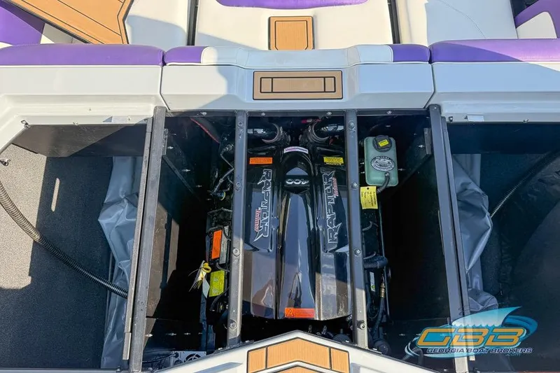 Slide: The Image of 2022 Tigé Z3 boat engine compartment with Raptor motor, purple and white seating. - 23