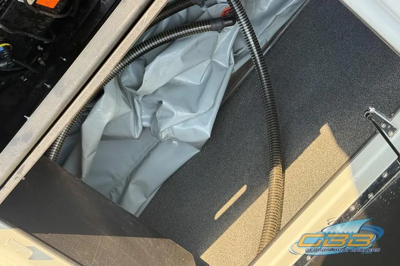 Slide: The Image of 2022 Tigé Z3 boat storage compartment with hoses and equipment. - 26