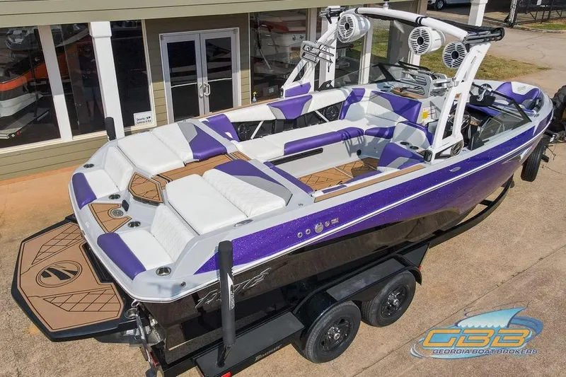 Slide: The Image of 2022 Tigé Z3 boat with purple and white interior, parked on a trailer. - 7