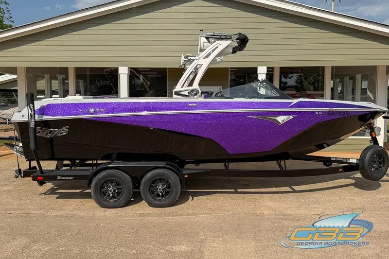 Slide: The Image of 2022 Tigé Z3 boat with purple and black design on a trailer. - 9