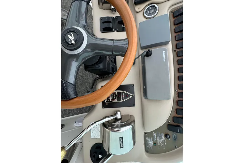 Slide: The Image of 2000 Sea Ray Sundancer 310 helm with wooden steering wheel and control panel. - 10