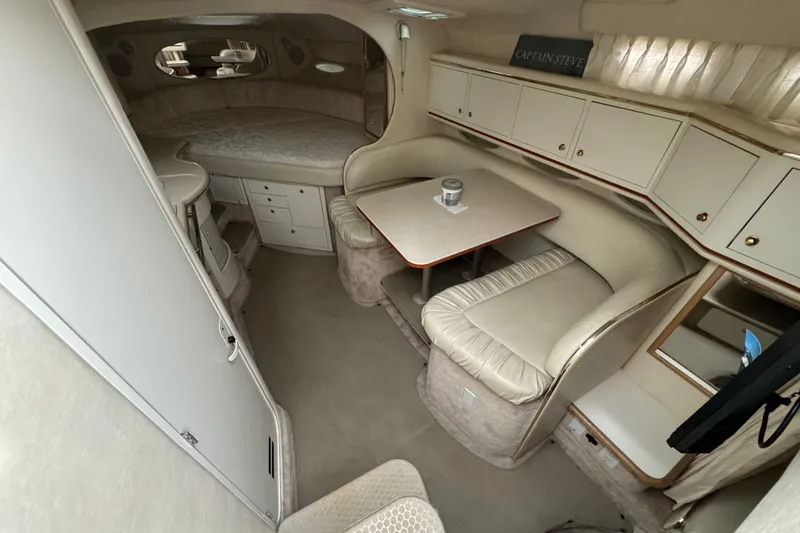 Slide: The Image of Interior of 2000 Sea Ray Sundancer 310 yacht with cozy seating and dining area. - 12