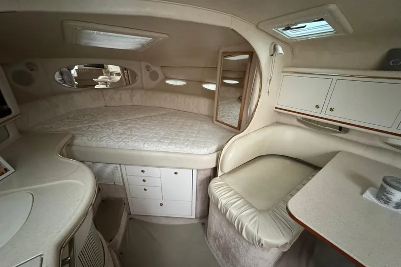 Slide: The Image of Interior of 2000 Sea Ray Sundancer 310, featuring cozy cabin with bed and seating area. - 15