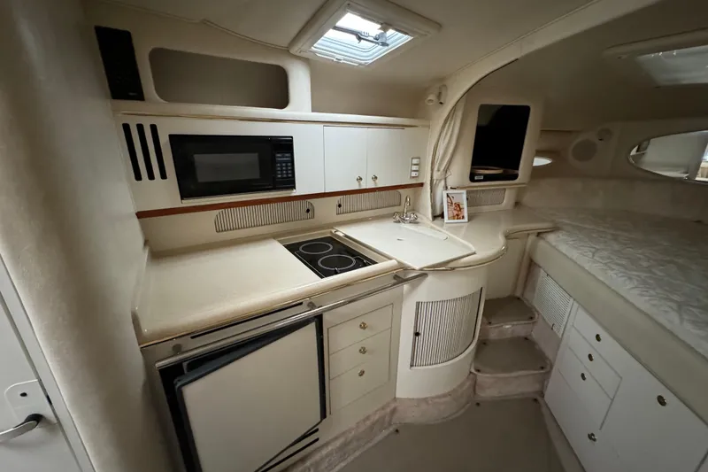 Slide: The Image of Interior of 2000 Sea Ray Sundancer 310 yacht with kitchenette and sleeping area. - 19