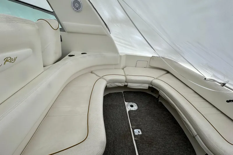 Slide: The Image of Interior seating of a 2000 Sea Ray Sundancer 310 boat, featuring white upholstery. - 5