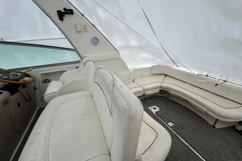 Slide: The Image of Interior of a 2000 Sea Ray Sundancer 310 boat with white seating and steering wheel. - 6