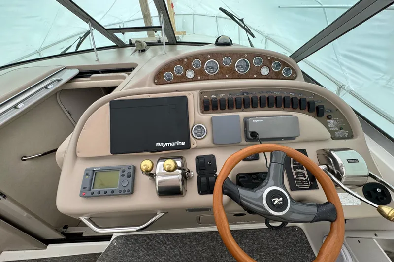 Slide: The Image of Cockpit of 2000 Sea Ray Sundancer 310 with steering wheel and navigation instruments. - 8