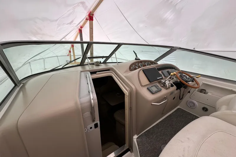Slide: The Image of Interior view of a 2000 Sea Ray Sundancer 310 boat cockpit under cover. - 9