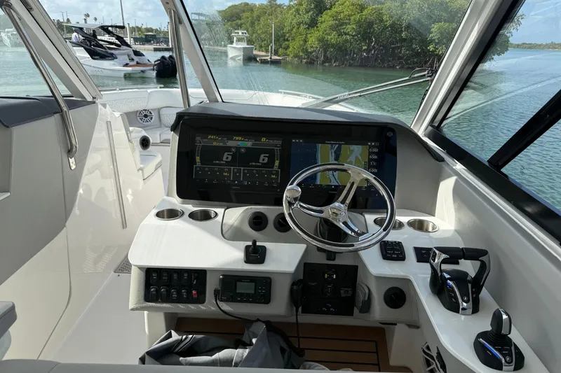 Slide: The Image of Cockpit of 2023 Regal LX36 boat with advanced navigation system and controls. - 11