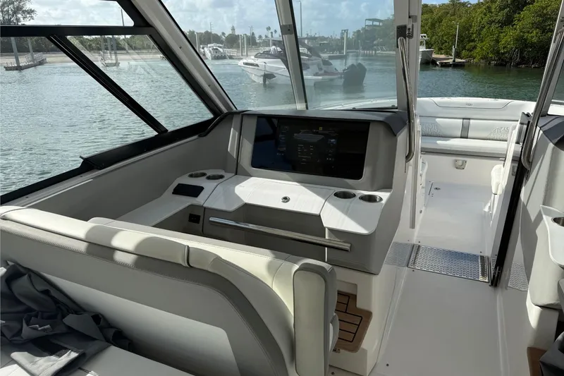 Slide: The Image of Interior of 2023 Regal LX36 boat with modern dashboard and seating. - 12