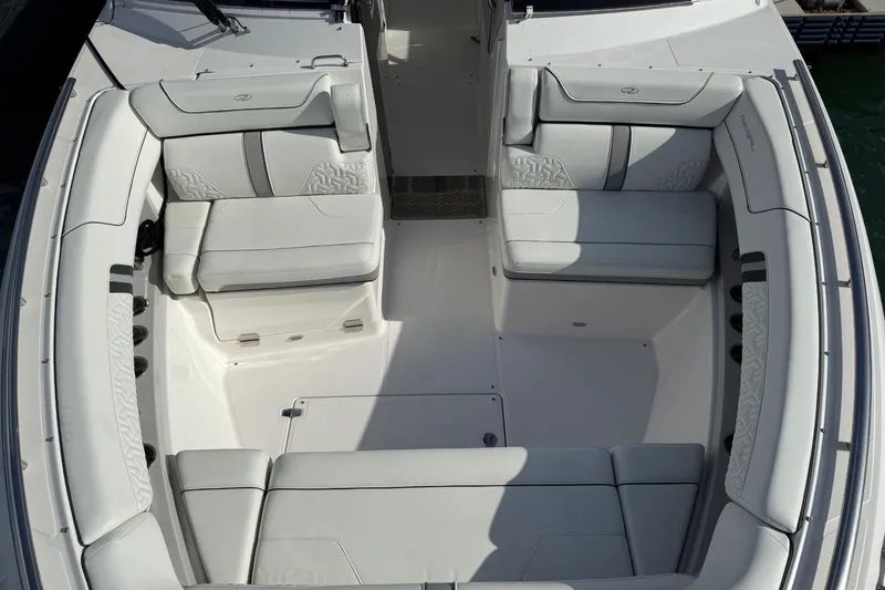 Slide: The Image of Luxurious seating area on a 2023 Regal LX36 boat, featuring elegant white upholstery. - 15