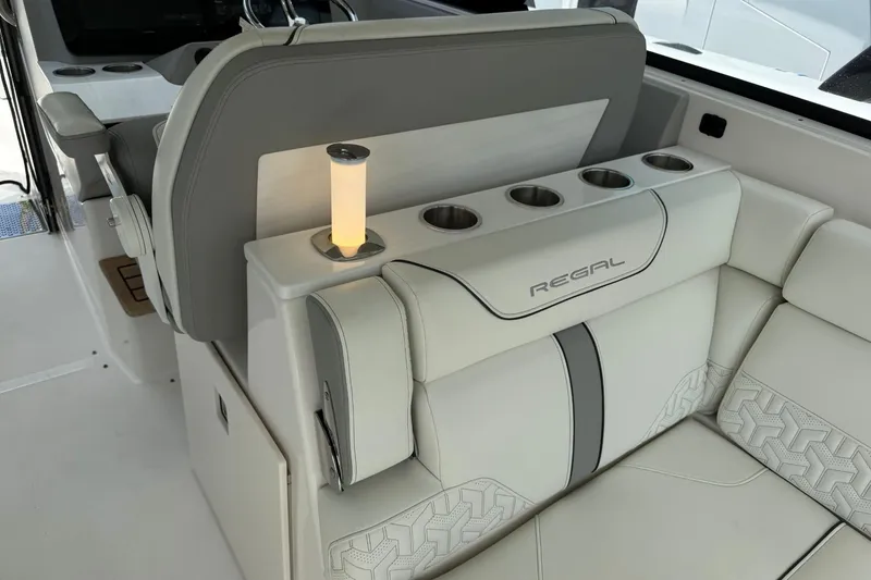 Slide: The Image of Luxurious interior of 2023 Regal LX36 boat with elegant seating and cup holders. - 18