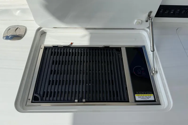 Slide: The Image of Built-in Kenyon grill on 2023 Regal LX36 boat, featuring sleek design and modern controls. - 21
