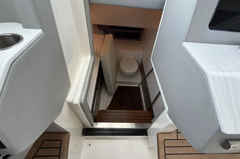 Slide: The Image of 2023 Regal LX36 boat interior with compact bathroom and modern design. - 25