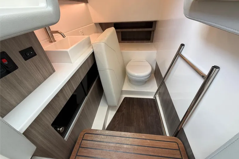 Slide: The Image of 2023 Regal LX36 boat interior with modern bathroom and wooden flooring. - 26