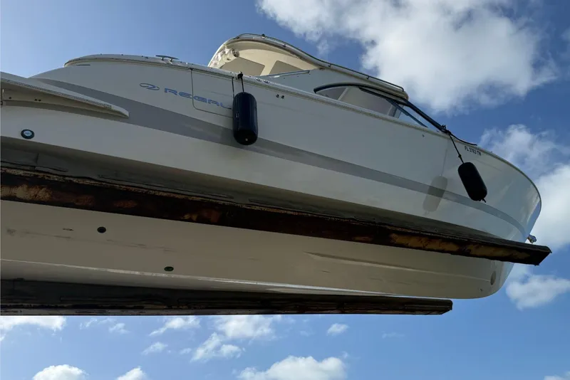 Slide: The Image of 2023 Regal LX36 boat against a blue sky with clouds. - 29