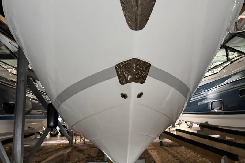 Slide: The Image of 2023 Regal LX36 boat hull in storage, showcasing sleek design and craftsmanship. - 32