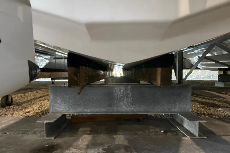 Slide: The Image of 2023 Regal LX36 boat hull resting on a sturdy metal support structure. - 34