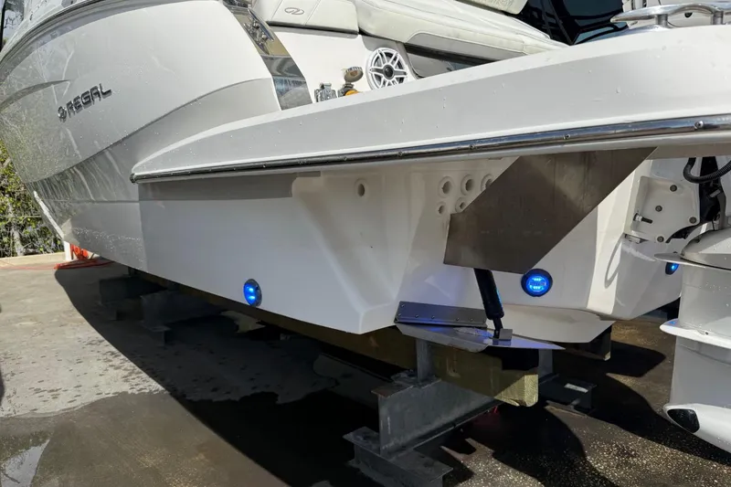 Slide: The Image of 2023 Regal LX36 boat hull with blue LED lights and sleek design. - 35